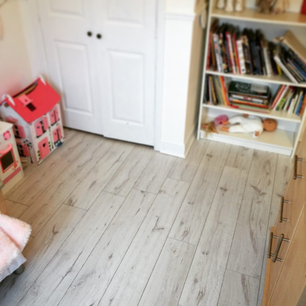 book shelf with white door and doll house